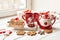 Christmas cookies and mug of hot tea, christmas time. Christmas gingerbread, candy, coffee in red cup on wooden table on frosty