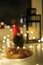 Christmas cookies stand on the windowsill next to a Christmas gnome and garlands