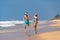 Christmas couple happy relaxing on beach running on sand
