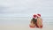 Christmas couple relaxing on beach winter vacation