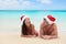 Christmas couple relaxing on beach winter vacation