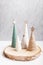 Christmas craft background with handmade yarn cone xmas trees in natural colors.