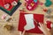 Christmas crafting, hands holding scissors and cutting the shape of christmas stocking