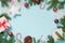 Christmas creative border with white snowflakes and branches on blue Flat lay. Top view. Copy space. Drawn snow.