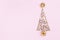 Christmas creative fir tree from confetti stars, serpentine and golden balls on pink background top view. Flat lay.