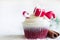 Christmas cupcake with holiday ornament and cinnamon on white background