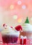 Christmas cupcake and holiday ornament on colorful defocused background