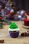 Christmas cupcakes. Candles and an elegant spruce. Selective focus, place for text.