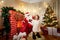 In Christmas curly little girl in boots with Santa Claus in the