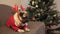 Christmas cute pug dog sitting in reindeer horns hat with gift and waiting for the holiday at home. Merry Christmas and