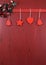 Christmas dark red vintage recycled wood background with hanging wood ornaments