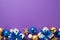 Christmas Day concept. Top view photo of gift boxes with ribbon bows blue gold baubles and star ornaments on isolated violet