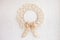 Christmas decor. Macrame wreath for Christmas and the new year on a white decorative plaster wall. Natural cotton thread, linen