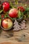 Christmas decor with red apples, moss and mistletoe twigs