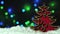 Christmas decor red wooden Christmas tree on the snow over blured bokeh lights on the background