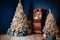 Christmas decor in a room with blue walls, two Christmas trees decorated with toys and lights,