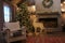 Christmas decorated bedroom with tree, deer, fire place, wood and garland