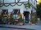 Christmas decorated boutique entrance with holiday lights, American flag