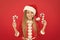 Christmas decorating ideas. Child Santa Claus costume hold christmas candy cane. Create unique decorations. Sweet