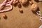 Christmas decoration background, fir tree, textile, beads, gifts, old paper, nuts and other stuff on sackcloth. Empty space for te