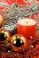 Christmas decoration with balls and lighted candle