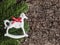 Christmas decoration on bark, evergreens, rocking horse