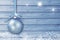 Christmas decoration on a blue wooden board with white snow, snowflakes, ice crystals. Simple Christmas, New Year card