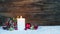 Christmas decoration with candle and ornaments in red and golden colors