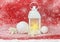 Christmas decoration. Christmas lantern, white balls, white openwork flowers poinsettia on red glitter background covered snow