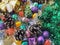 Christmas decoration collection. Beautifully arranged shiny bright Christmas tree decorations, green foil, gifts. Red, purple,