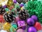 Christmas decoration collection. Beautifully arranged shiny bright Christmas tree decorations, green foil, gifts. Red, purple,