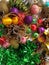 Christmas decoration collection. Beautifully arranged shiny bright Christmas tree decorations, green foil, gifts. Red, purple,