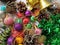 Christmas decoration collection. Beautifully arranged shiny bright Christmas tree decorations, green foil, gifts. Red, purple,