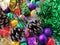 Christmas decoration collection. Beautifully arranged shiny bright Christmas tree decorations, green foil, gifts. Red, purple,