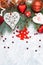 Christmas decoration collection: hearts, branches and bauble decor on stone background. Xmas backdrop for your greeting card with