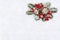 Christmas decoration. Cones pine, twigs christmas tree, red balls, red berries on snow with space for text. Top view, flat lay