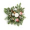 Christmas decoration consisting of fir twigs, shiny balls, cones around the candle, covered with snow on a white background