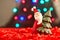 Christmas decoration, a cute ceramic souvenir-Santa Claus with a Christmas tree stands on a New Year`s decorated window