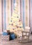 Christmas decoration interior with tree presents and baby rocking-chair