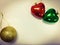 Christmas decoration are on orange background. The colorful balls and heart adjust with warm tone, there are empty space on the