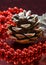 Christmas decoration with a pine cone and a shiny red beaded garland
