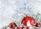 Christmas decoration. Red ball on frosty background with snow br