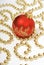 Christmas decoration: red ball and golden beads