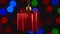 Christmas decoration, red gift hanging on the bokeh background of flashing lights