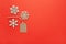 Christmas decoration, three little wooden snowflakes and craft tag on bright red background, copy space. Festive, New Year, sales