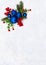 Christmas decoration. Twigs christmas tree, christmas blue balls and red berries on snow with space for text. Top view, flat lay