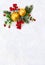 Christmas decoration. Twigs christmas tree, christmas yellow balls and red berries on snow with space for text. Top view, flat lay