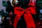 Christmas decorations against blurred background. Red Christamas ribbon