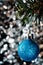Christmas decorations: a blue bauble on and eco-tree