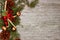 Christmas decorations - branches of coniferous trees with decorations on a wooden background